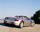 POR 04 RK0581 03
2005 Porsche Carrera GT Convertible Silver 3/4 Rear View On Pavement Hill By Tree