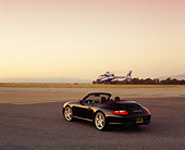POR 04 RK0615 02
2005 Porsche 911 S Carrera Convertible Black 3/4 Rear View On Pavement Helicopter In Flight Filtered