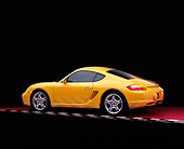 POR 04 RK0650 01
2006 Porsche Cayman S Yellow 3/4 Rear View On Red Checkered Floor Studio
