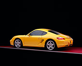 POR 04 RK0651 01
2006 Porsche Cayman S Yellow 3/4 Rear View On Red Floor Studio
