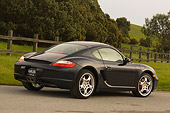POR 04 RK0662 01
2006 Porsche Cayman S Black Rear 3/4 View On Pavement By Fence Grass And Trees