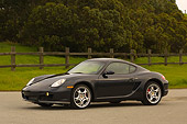POR 04 RK0663 01
2006 Porsche Cayman S Black Front 3/4 View On Pavement By Fence Grass And Trees