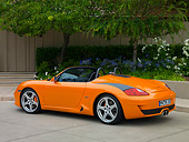 POR 04 RK0693 01
2007 Porsche RUF Spyder Orange 3/4 Rear View On Pavement By Trees And Flowers