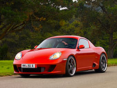 POR 04 RK0702 01
2007 Porsche RUF RK Coupe Red 3/4 Front View On Pavement By Grass And Trees