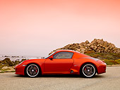 POR 04 RK0704 01
2007 Porsche RUF RK Coupe Red Profile View On Pavement By Ocean And Rocks