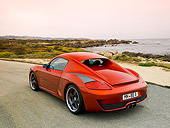 POR 04 RK0705 01
2007 Porsche RUF RK Coupe Red 3/4 Rear View On Pavement By Ocean And Rocks