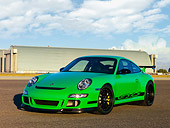 POR 04 RK0751 01
2007 Porsche 911 GT3 RS Green 3/4 Front View On Pavement By Hangar Blue Sky