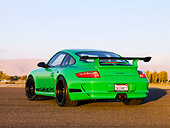 POR 04 RK0758 01
2007 Porsche 911 GT3 RS Green 3/4 Rear View On Pavement By Trees Mountain Sky