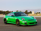 POR 04 RK0764 01
2007 Porsche 911 GT3 RS Green 3/4 Front View On Pavement By Trees Mountain Sky Buildings
