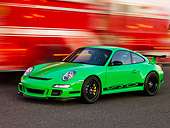 POR 04 RK0766 01
2007 Porsche 911 GT3 RS Green 3/4 Front View On Pavement By Passing Fire Truck