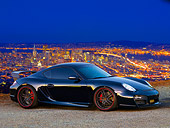 POR 04 RK0802 01
2008 Porsche Cayman S TechArt Black 3/4 Front View On Pavement City Lights
