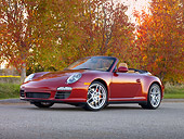 POR 04 RK0822 01
2009 Porsche 911 Carrera 4S Convertible Red 3/4 Front View On Pavement By Trees