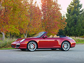 POR 04 RK0823 01
2009 Porsche 911 Carrera 4S Convertible Red 3/4 Front View On Pavement By Trees