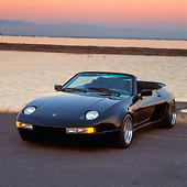 POR 05 RK0018 05
1990 Porsche 928 S Koenig Cabriolet 3/4 Front View On Pavement By Water