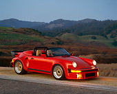 POR 07 RK0028 02
1989 Porsche 911 Speedster Anniversary Red 3/4 Side In Hills Lights On At Dusk