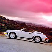 POR 07 RK0051 04
1989 Porsche Speedser Limited Edition White Slanted Side View On Pavement Filtered