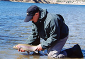 REC 04 DS0008 01
Man Kneeling In Lake Holding Fish