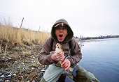 REC 04 DS0009 01
Man Kneeling By Lake Holding Fish