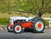 TRA 01 RK0130 01
1939 Ford 9N Tractor White And Red 3/4 Side View On Pavement By Fence And Trees