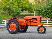 TRA 01 RK0139 01
1946 Allis-Chalmers WD Tractor Orange Profile View On Gravel By Fence And Trees