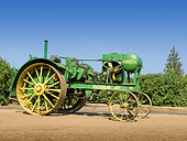 TRA 01 RK0156 01
1920 Waterloo Boy Model N (First John Deere) Green Profile View On Dirt By Shrubs