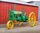 TRA 01 RK0161 01
1935 John Deere Model B Green And Yellow 3/4 Side View On Dirt By Shed