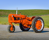 TRA 01 RK0182 01
1958 Allis-Chalmers D-14 Tractor Orange 3/4 Front View On Pavement By Vineyard