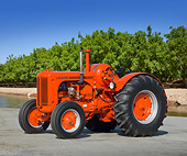 TRA 01 RK0186 01
1945 Case LA Propane Tractor Flambeou Red 3/4 Side View On Pavement By Water And Trees