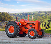 TRA 01 RK0189 01
1945 Case LA Propane Tractor Flambeou Red 3/4 Side View On Gravel By Grassy Hills