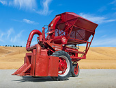 TRA 01 RK0204 01
1944 Farmall Tractor With 1952 McCormick Cotton Picker Red 3/4 Side View On Pavement By Dry Grass