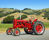TRA 01 RK0207 01
1953 Farmall Super C Tractor Red 3/4 Side View On Pavement By Grassy Hills