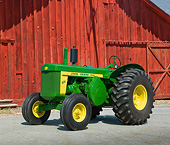 TRA 01 RK0227 01
John Deere 820 Tractor Green And Yellow 3/4 Front View On Pavement By Red Barn