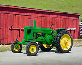 TRA 01 RK0230 01
John Deere Tractor Green And Yellow 3/4 Side View On Pavement By Red Barn