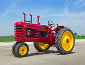 TRA 01 RK0250 01
1947 Massey-Harris 44-6 Tractor Red And Yellow 3/4 Side View On Gravel By Farm