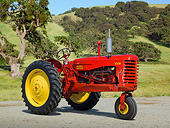 TRA 01 RK0254 01
1949 Massey-Harris 44-6 Tractor Red And Yellow 3/4 Side View On Gravel By Grassy Hills