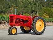 TRA 01 RK0255 01
1951 Massey-Harris 30 GR Tractor Red And Yellow 3/4 Side View On Gravel By Trees