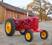 TRA 01 RK0257 01
1953 Massey-Harris 44 Diesel Tractor Red And Yellow 3/4 Front View On Gravel By Wooden Shed