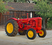 TRA 01 RK0259 01
1953 Massey-Harris 55 Diesel Tractor Red And Yellow 3/4 Side View On Dirt By Wooden Shed