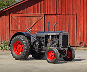 TRA 01 RK0263 01
1929 McCormick-Deering 15-30 Tractor IH Gray 3/4 Side View On Pavement By Red Barn