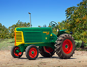 TRA 01 RK0264 01
1949 Oliver 66 Standard Tractor Green, Yellow And Red 3/4 Side View On Dirt By Trees