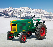 TRA 01 RK0265 01
1949 Oliver 66 Standard Tractor Green, Yellow And Red 3/4 Side View On Gravel By Snow Covered Mountains