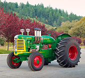 TRA 01 RK0273 01
1957 Oliver Super 99 Tractor Green, Yellow And Red 3/4 Side View On Gravel By Autumn Trees