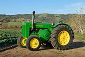 TRA 01 RK0284 01
1980 John Deere Style D Tractor Green And Yellow 3/4 Side View On Dirt At Farm