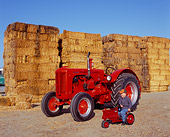 TRA 01 RK0049 04
1947 LA Case Tractor Red 3/4 Front View With Boy On Little Tractor By Hay Stacks