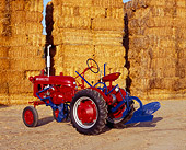 TRA 01 RK0061 02
1948 Farmall Cub Red Tractor 3/4 Rear View On Dirt By Stacks Of Hay