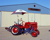 TRA 01 RK0064 01
1948 Farmall Cub Red Tractor With Umbrella 3/4 Side View By Building