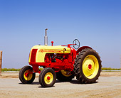 TRA 01 RK0080 03
1956 Cockshutt 35 Deluxe Red And Yellow Tractor 3/4 Front View On Dirt Blue Sky
