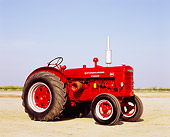 TRA 01 RK0088 02
1947 McCormick Deering W-4 Standard Red Tractor 3/4 Side View On Dirt Blue Sky