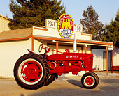TRA 01 RK0103 02
1952 Farmall H Red Tractor Profile View By Building