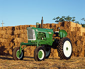 TRA 01 RK0114 02
1960 Oliver 770 Green And White Tractor 3/4 Front By Hay Stacks